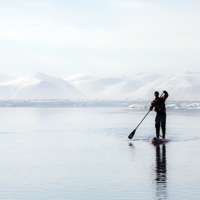 Man on paddleboard in Arctic